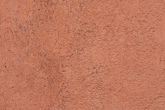 Close-up of a structure of red plaster on the wall. Background image. Conceptual wallpaper