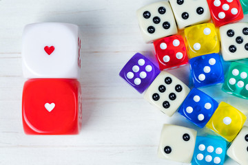 Two red and white Valentines Day dice apart from others.