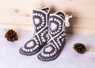 crochet boots for adults on wooden background