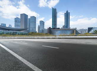 Obraz na płótnie Canvas empty asphalt road with city skyline background in china.