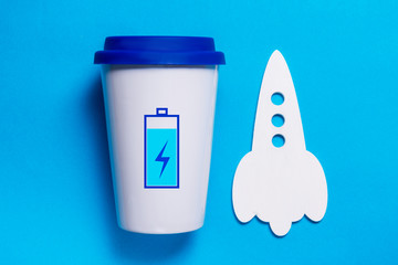 Cup of coffe with charged battery, high energy concept