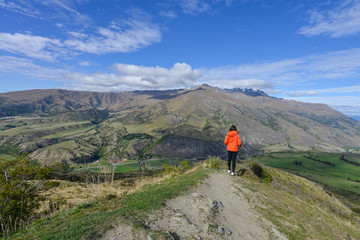 Asian woman tourist stand on the hill in New Zealand