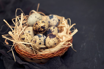 quail eggs in small dish on wooden background