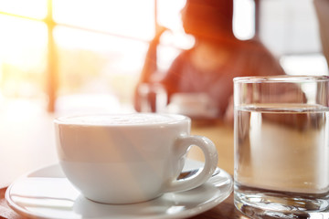 Businesswoman with smartphone and coffee in the morning