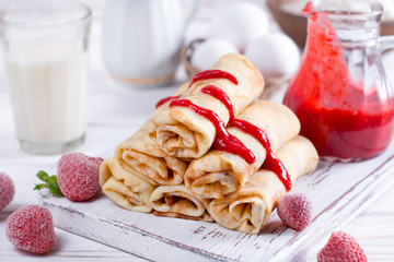 Pancakes stuffed with cottage cheese and berry sauce