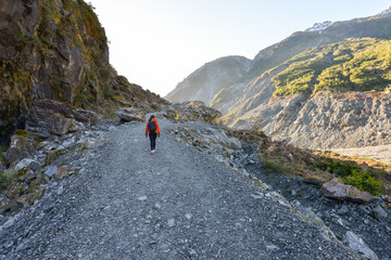 Woman tourist trekking to the Fox Glacier in New Zealand