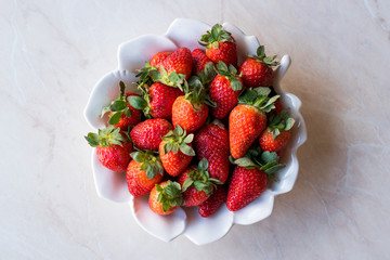 Fresh Organic Ripe Strawberries in white Ceramic Bowl.