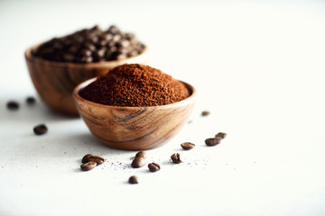 Ingredients for making caffeine drink - coffee beans, ground and instant coffee on light concrete background, copy space. Banner