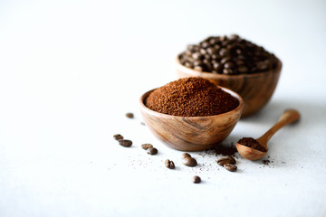 Ingredients for making caffeine drink - coffee beans, ground and instant coffee on light concrete background, copy space. Banner