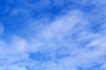 Light blue sky with clouds, may be used as background .