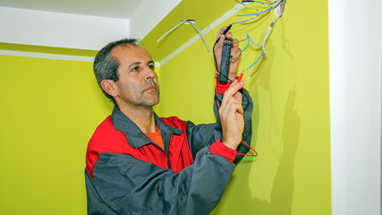 Electrician Measuring With a Digital Multimeter
