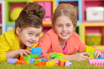 girls playing with colorful blocks