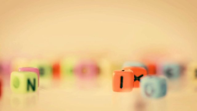 colorful English word cube falling on to white background ,English language learning concept , retro color style with 4k Dci resolution.