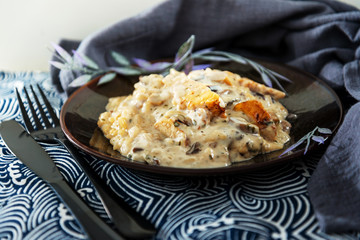 Tasty risotto with chicken, fresh herbs vegetables on a white plate