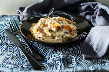 Tasty risotto with chicken, fresh herbs vegetables on a white plate