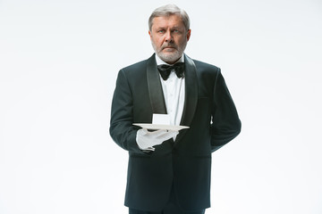 Senior waiter holding tray