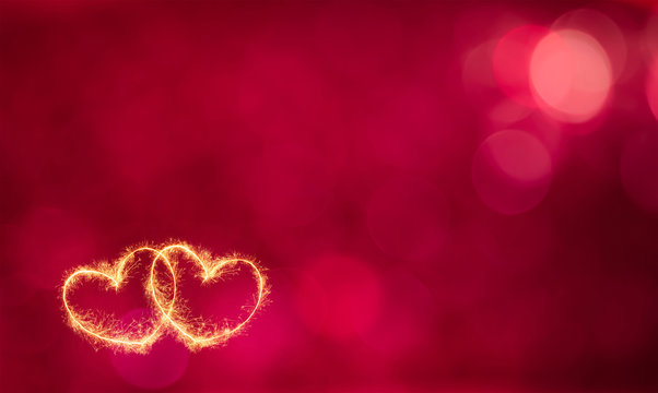 Red Bokeh Background With Two Glowing Hearts