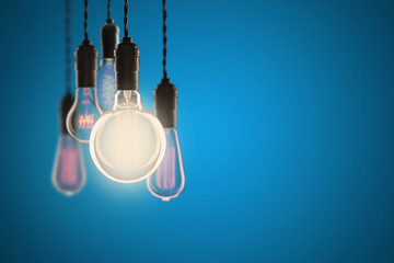 Vintage bulbs on color background - idea, innovation, teamwork and leadership concept. Space for text