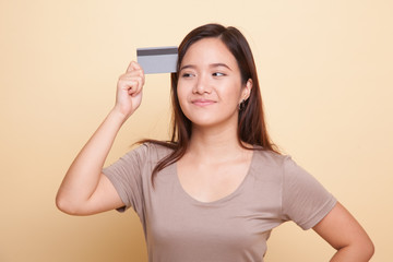 Young Asian woman think with a blank card.