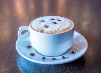 A cup of fresh aromatic coffee in a cafe
