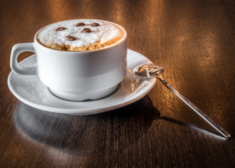 A cup of fresh aromatic coffee in a cafe