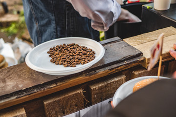Plastic plate with coffee beans in a cafe on the street