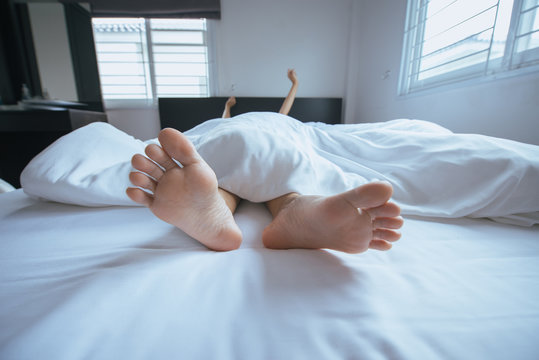 Close up of  barefoot,Feet and stretch oneself on the bed after waking up