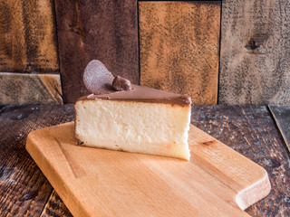 Tasty cheesecake on a wooden board in a cafe