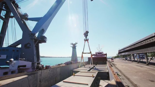 Ukraine - May 2016: Pontoon crane near pier awaiting for oversize cargo deployment with sunflare