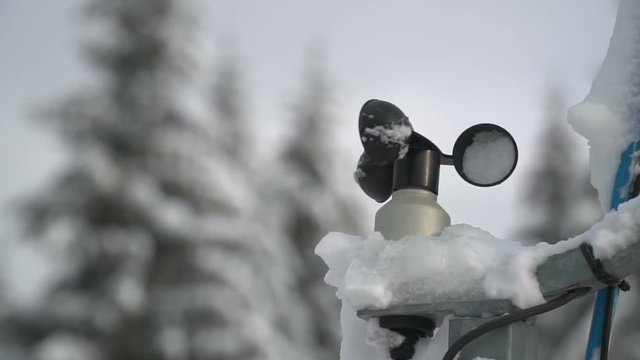 Hydro meteorological center. Wind speed meter anemometer installed in the mountains. Meteorological equipment against the background of trees in the snow in winter