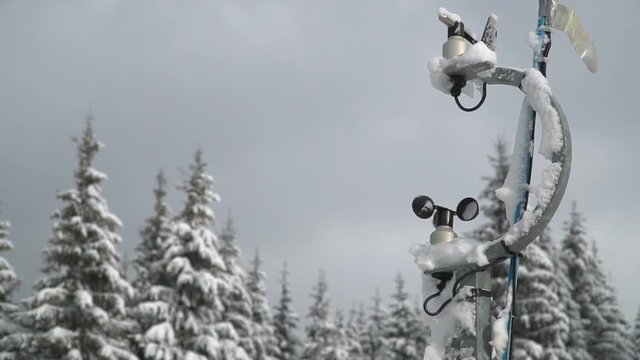 Hydro meteorological center. Wind speed meter anemometer installed in the mountains. Meteorological equipment against the background of trees in the snow in winter