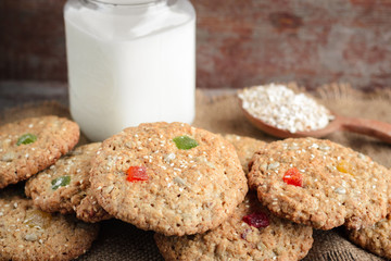 Oatmeal cookies and a glass mug with rustic milk on a wooden table