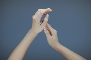 Beautiful woman hands with perfect french nail art posing like ballet dancer, sensual studio shot