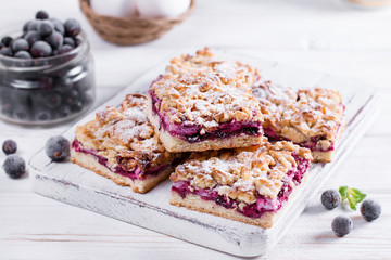 Tart, pie, cake with jellied strawberry, bilberries on white background. Homemade pie for tea time