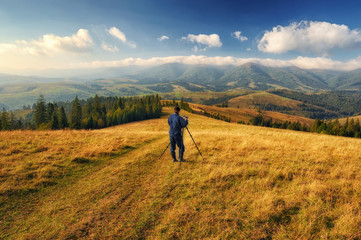 Fototapeta premium autumn morning. dawn in the Carpathian mountains. photographer, taking off the dawn. man in the mountains