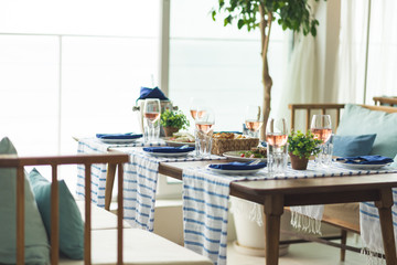 Restaurant table set with glasses, napkins and cutlery