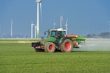 Tractor with fertilizer spreader on the field  - 8941