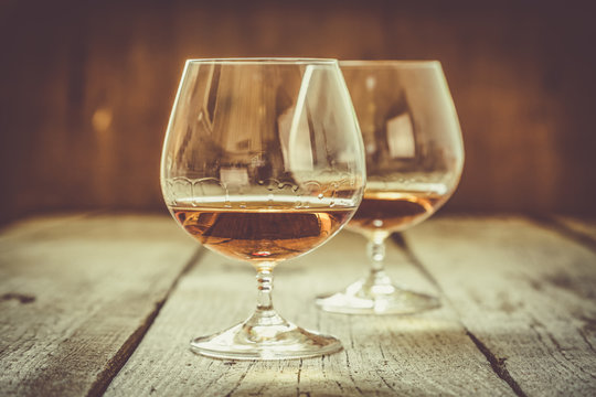 Cognac in glasses on rustic backgrpund