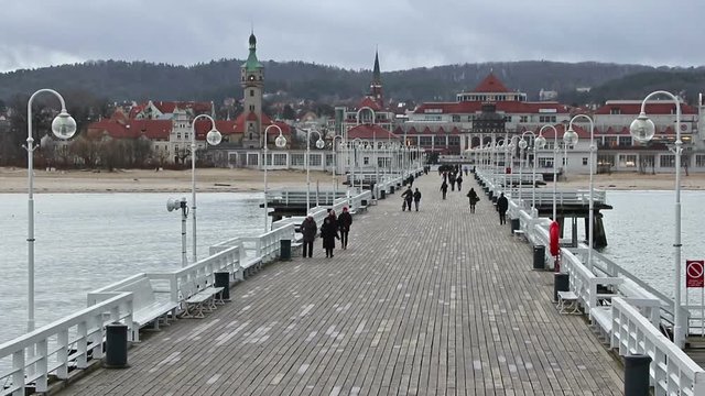 People walking on a Pier (Molo) in Sopot city, Poland. Built in 1827 with 511m long it is the longest wooden pier in Europe