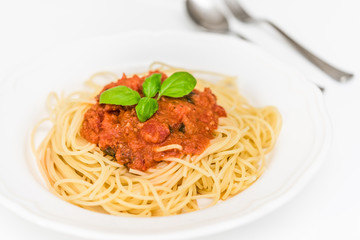 tatsty fresh spaghetti with tomato sauce fresh basil isolated on white background