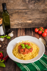 Spaghetti pasta with tomato sauce  and fresh basil - homemade healthy italian pasta on rustic wooden background