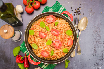 Spaghetti pasta with tomato sauce  and fresh basil - homemade healthy italian pasta on rustic wooden background