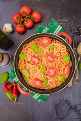 Spaghetti pasta with tomato sauce  and fresh basil - homemade healthy italian pasta on rustic wooden background