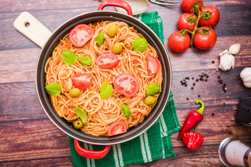 Spaghetti pasta with tomato sauce  and fresh basil - homemade healthy italian pasta on rustic wooden background