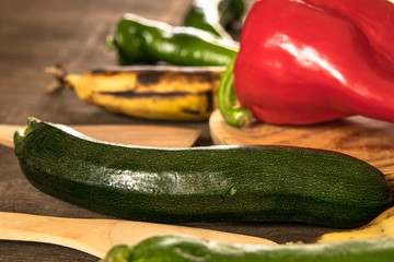 Fruits and vegetables on a rustic table:lemons, zucchini,peppers, bananas, asparagus.Healthy food