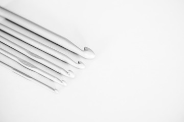 set of aluminum crochet knitting needles in different sizes. Black and white photo