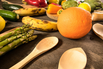 Fruits and vegetables on a rustic table:lemons, zucchini,peppers, bananas, asparagus.Healthy food