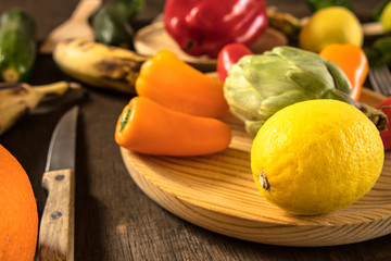 Fruits and vegetables on a rustic table:lemons, zucchini,peppers, bananas, asparagus.Healthy food