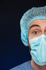 Close up half portrait of a surprised male surgeon