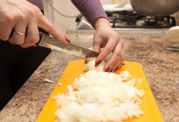 A girl is cutting a bow with a knife